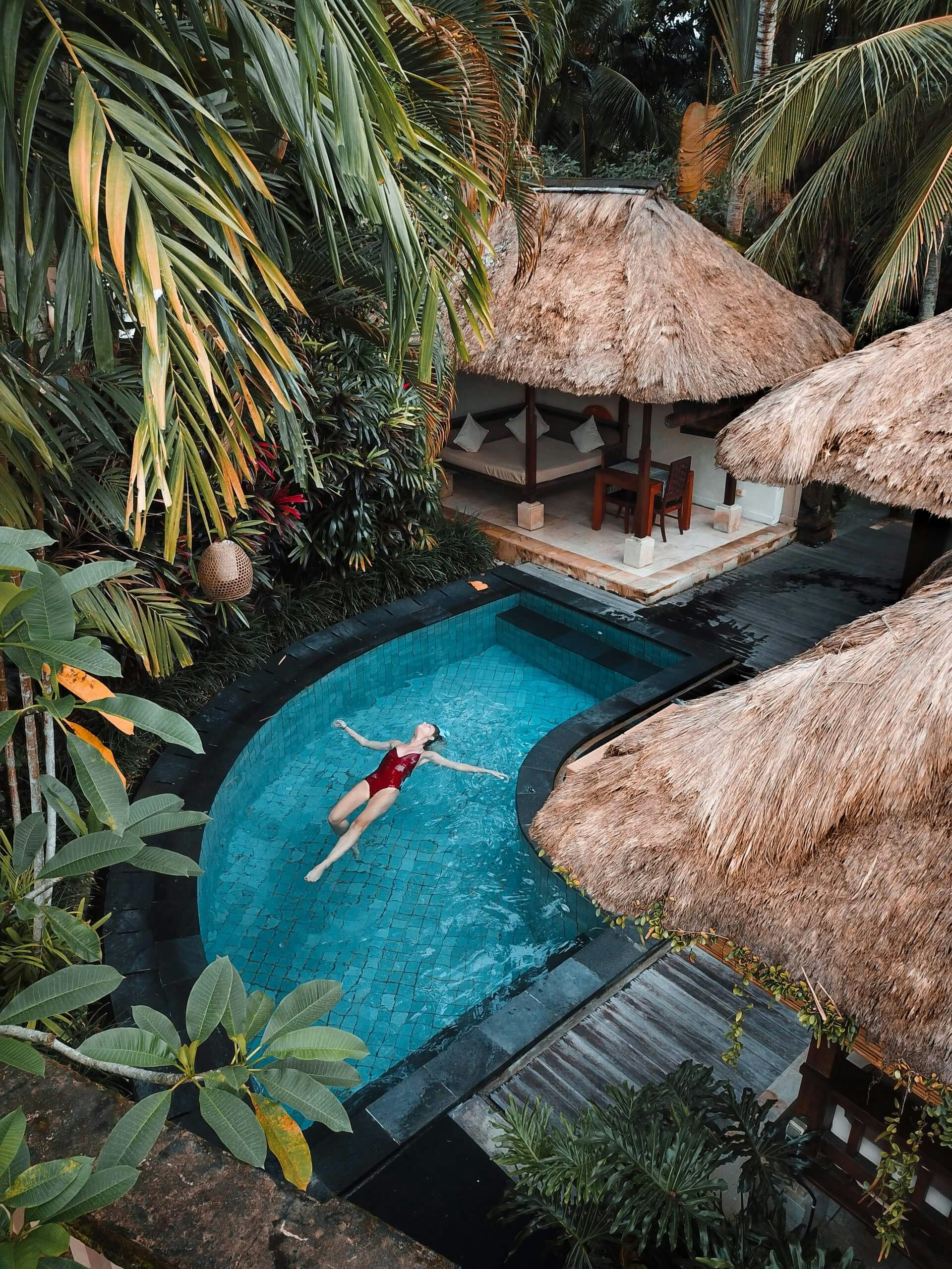 Woman relaxing in tropical pool